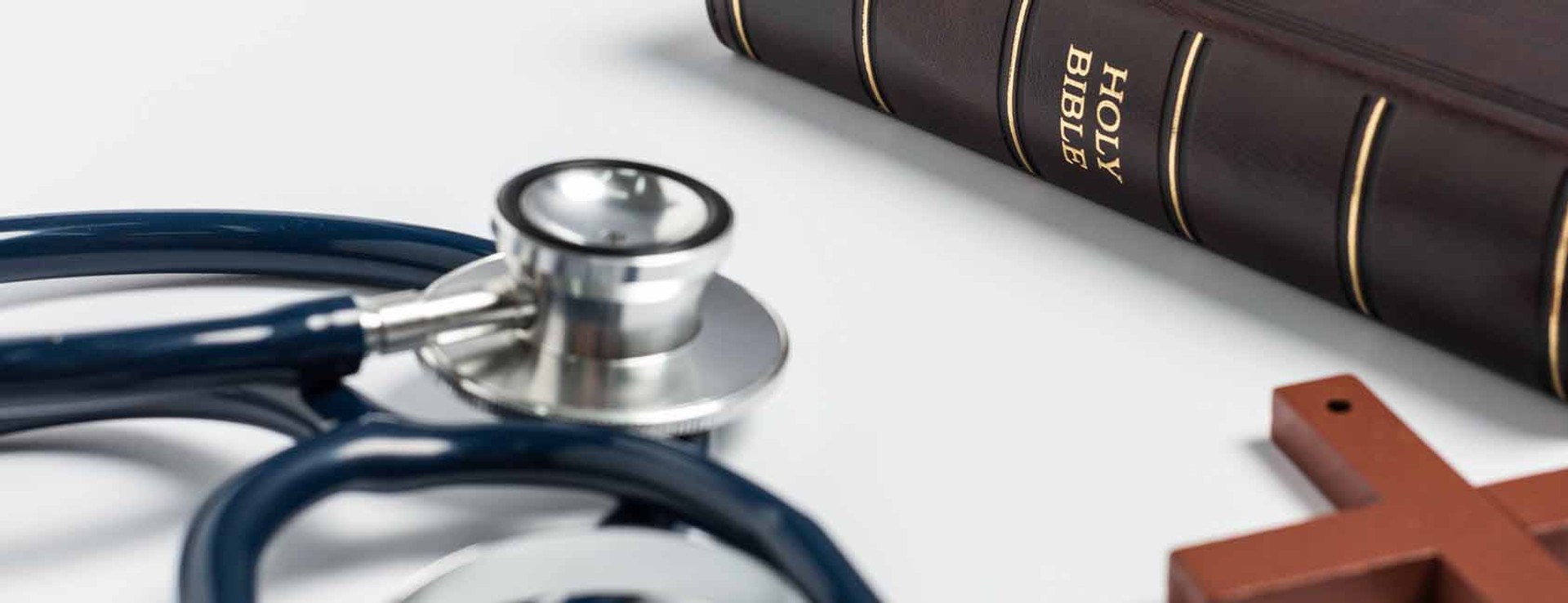 Bible, cross and stethoscope