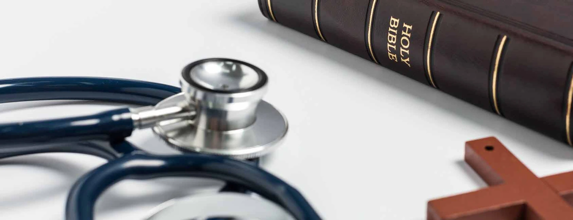 Bible, cross and stethoscope