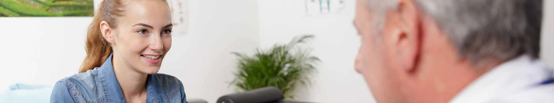 Woman handing her health insurance ID card to a healthcare professional